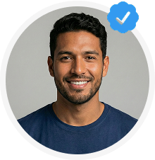 Smiling man with short dark hair and a beard, wearing a navy blue shirt, with a blue verified checkmark badge.
