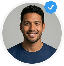 Smiling man with short dark hair and a beard, wearing a navy blue shirt, with a blue verified checkmark badge.